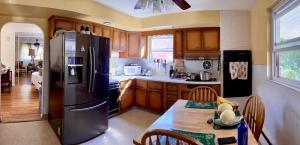 a kitchen with a wooden table and a refrigerator at ABnB Superhost - Siri's Favorite Place in Havertown