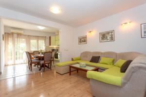 a living room with a couch and a table at Apartments Ave in Podstrana