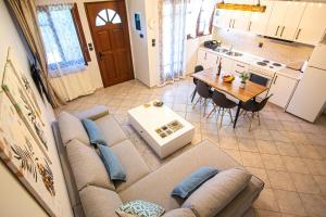 a living room with a couch and a table at Palmeira Sea & City in Preveza