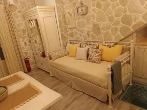 a bedroom with a bed with yellow pillows at TheHouse1905 in Parga