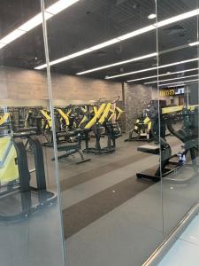 a gym with rows of treadmills and mirrors at luxury studio with amazing seaview in Ras al Khaimah