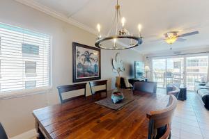 a dining room with a table and a couch at Water View 402 in Clearwater Beach