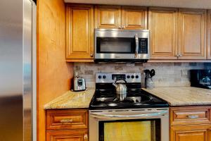 a kitchen with a stove and a microwave at Water View 402 in Clearwater Beach