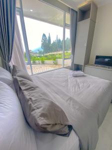 Krevet ili kreveti u jedinici u objektu Algara Puncak Hotel