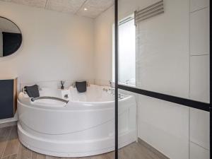 a white bathroom with a sink and a shower at 8 person holiday home in Otterup-By Traum in Otterup +50 photos