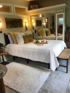 a bedroom with a large bed with a large mirror at The Secret Garden Room in Kapaa