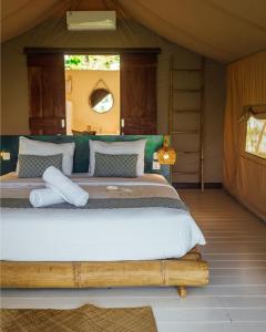 a bedroom with a large bed in a tent at Autentik Penida "Glamping" - Adults only in Nusa Penida +41 photos