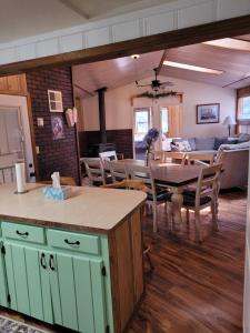 a kitchen and dining room with a table and chairs at Greer Point Trails End Cabins in Greer