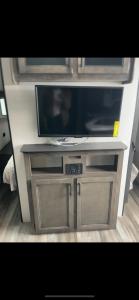 a flat screen tv sitting on top of a entertainment center at RV3 Wonderfull RV in MOVAL private freeparking Netflix in Moreno Valley