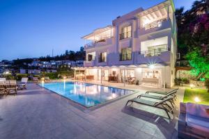 a house with a swimming pool in front of a building at Premium Villa - Amazing Seaviews in Bodrum City
