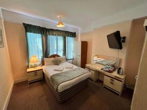 Tempat tidur dalam kamar di Belvedere Guest House, Great Yarmouth