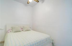 a white bedroom with a bed with a plaid blanket at 3 Bedroom Cozy Apartment In Sueca in Sueca