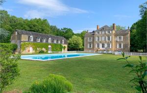 a large yard with a swimming pool in front of a building at Lovely Home In St Michel D,chavaignes With Outdoor Swimming Pool in Thorigné-sur-Dué