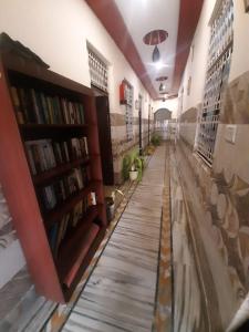 a hallway of a library with bookshelves at Friends Guest House & Hostel- near TAJ MAHAL in Agra
