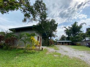 a house with a gravel road in front of it at เชอโคว์ เชอโคว์ โฮมสเตย์ in Sangkhla Buri