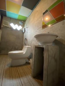 a bathroom with a sink and a toilet at เชอโคว์ เชอโคว์ โฮมสเตย์ in Sangkhla Buri