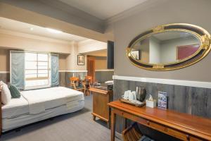 a bedroom with a bed and a mirror on the wall at 翠安儂風旅 in Taitung City +171 photos