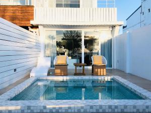 a swimming pool on the roof of a house at Whose Home Inn in Checheng