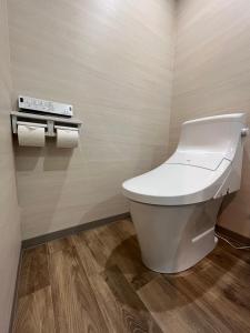 a bathroom with a toilet and two rolls of toilet paper at HOTEL ERENOA in Nagoya