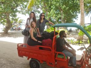 a group of people sitting on a toy car at Liberty Guesthouse Maldives in Mahibadhoo