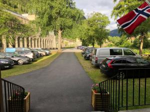 a parking lot with parked cars and a british flag at Rjukan Gjestehus in Rjukan