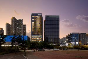 a group of tall buildings in a city at night at Take Hotel Seoul Gwangmyeong in Gwangmyeong