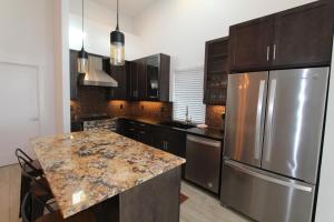 a kitchen with stainless steel appliances and a granite counter top at The Springs at Deerhaven in Gold Beach