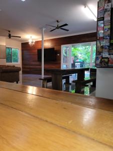 a kitchen with wooden floors and a wooden table at Travellers Paradise in Cairns