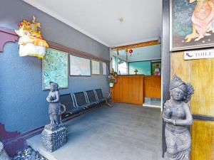 uma sala de espera com uma estátua de uma mulher em Capital O 91406 Agus Jaya Residence em Denpasar