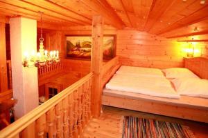 a bedroom with a bed in a wooden room at Mühlenhäuschen in Bad Koetzting