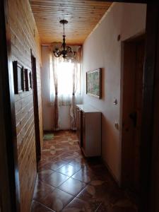 a hallway of a house with a window and a refrigerator at Elida Guest House in Shabla