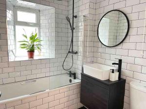 a white bathroom with a sink and a mirror at West Montgomery Place in Edinburgh