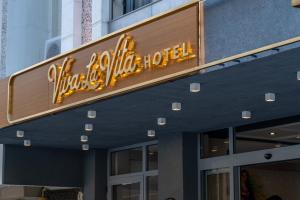 a sign for a walt disney world hotel at Viva La Vita Hotel in Konak