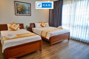 a hotel room with two beds and a sign that says ham at HANZ Sang Sang Hotel in Phu Quoc