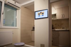 a kitchen with a tv on a wall in a room at LVC,LAC & NYC Apartshotel Faleza in Galaţi +104 photos