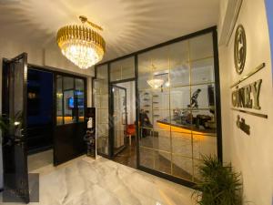 a lobby with glass doors and a chandelier at ANA GÜNEY Apart Otel in Nilüfer