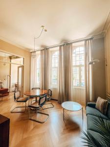 a living room with a table and a couch at Villa Theatro Heritage Apartments in Braga