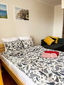 a bedroom with a bed with a black and white comforter at Willa Piano in Krynica Morska