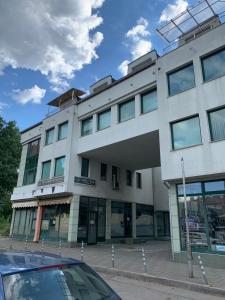 a building with a car parked in front of it at Minimalist Apartment in Sofia