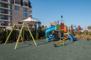 a playground with a slide and a swing set at Aquamarine - Wellness & SPA Hotel in Kranevo