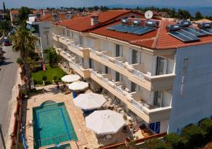 an aerial view of a hotel with a swimming pool and umbrellas at Melis Studios in Kallithea Halkidikis