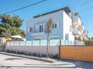 a white building with a fence in front of it at Greek Villa sunrelax with Private Pool Jacuzzi in Athens
