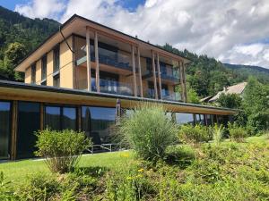 a house with large windows and a mountain at Atelier Ronacher in Annenheim