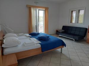 A bed or beds in a room at Apartments Dora, with a beautiful view of the bay, near the sea and center