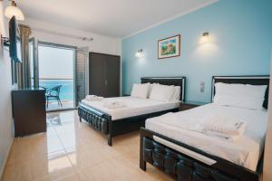 A bed or beds in a room at Ionion Beach Resort