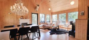 a dining room with a table and chairs and a chandelier at Dixon Cabin nr. 7 / Dixon sumarhús nr. 7 @Kirkjubraut in Talknafjordur