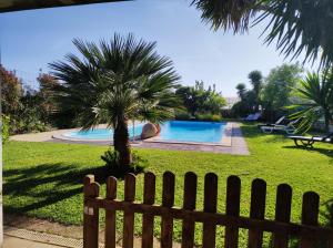 a wooden fence in front of a swimming pool at Vila com piscina a 5min da praia de Ofir - Esposende in Esposende