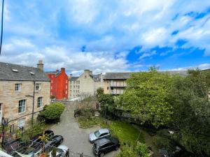 a city with cars parked in a parking lot at Charming 3 Bed Apartment in Old Town in Edinburgh