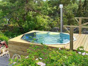 a hot tub sitting on top of a wooden deck at 4 person holiday home in KERSBERGA in Åkersberga