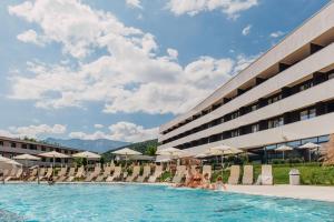 a group of people sitting in a pool at a hotel at Hotel Karawankenhof in Villach